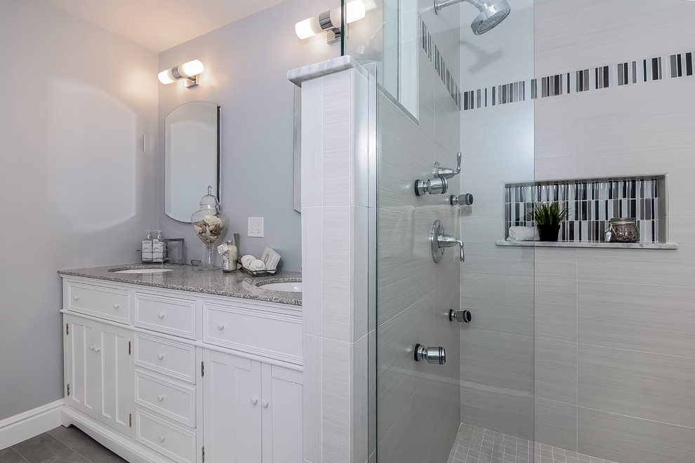 Design ideas for a mid-sized contemporary master bathroom in Boston with an undermount sink, beaded inset cabinets, white cabinets, granite benchtops, a corner shower, a two-piece toilet, gray tile, cement tile, purple walls and ceramic floors.