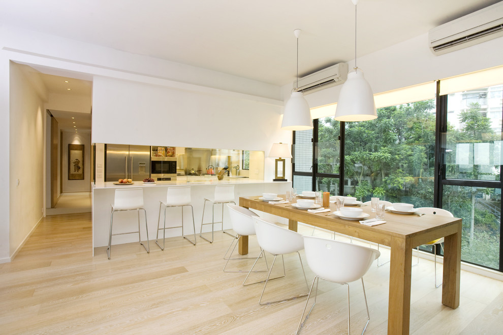 This is an example of a contemporary eat-in kitchen in Hong Kong with stainless steel appliances.