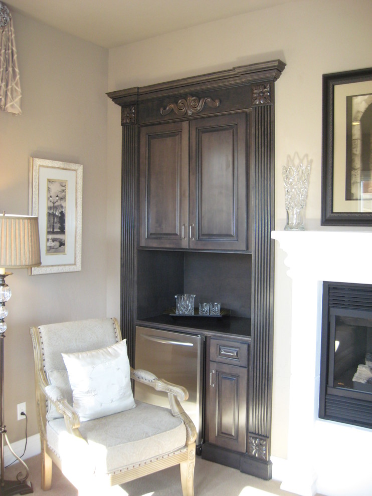 This is an example of a small traditional single-wall home bar in Las Vegas with no sink, raised-panel cabinets, grey cabinets, wood benchtops, grey splashback and carpet.