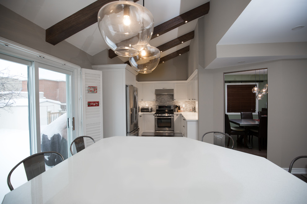 Example of a mid-sized transitional u-shaped medium tone wood floor and brown floor open concept kitchen design in Toronto with a double-bowl sink, recessed-panel cabinets, white cabinets, quartz countertops, gray backsplash, marble backsplash, stainless steel appliances, no island and white countertops