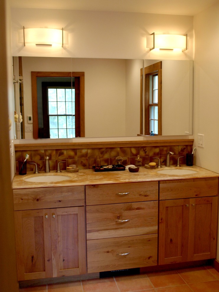 Design ideas for an arts and crafts bathroom in New York with an undermount sink, shaker cabinets, medium wood cabinets, onyx benchtops, a curbless shower, terra-cotta tile, white walls, terra-cotta floors and brown tile.