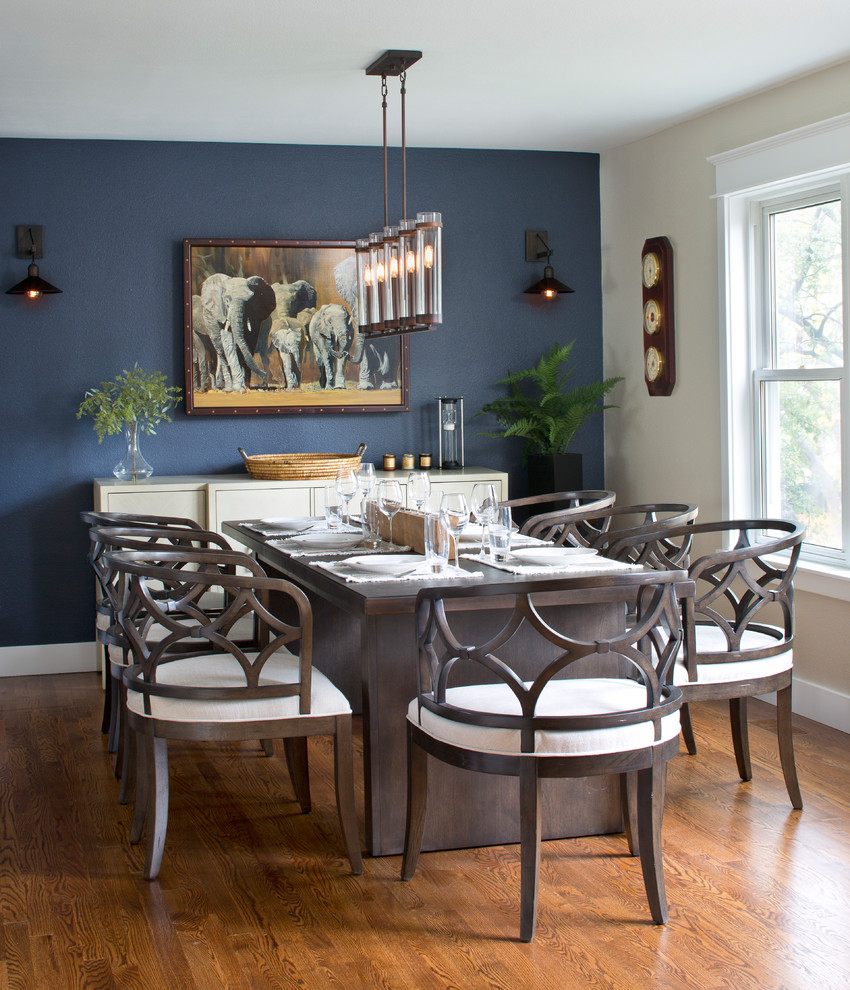 Photo of a large country open plan dining in Denver with blue walls, medium hardwood floors, no fireplace and brown floor.