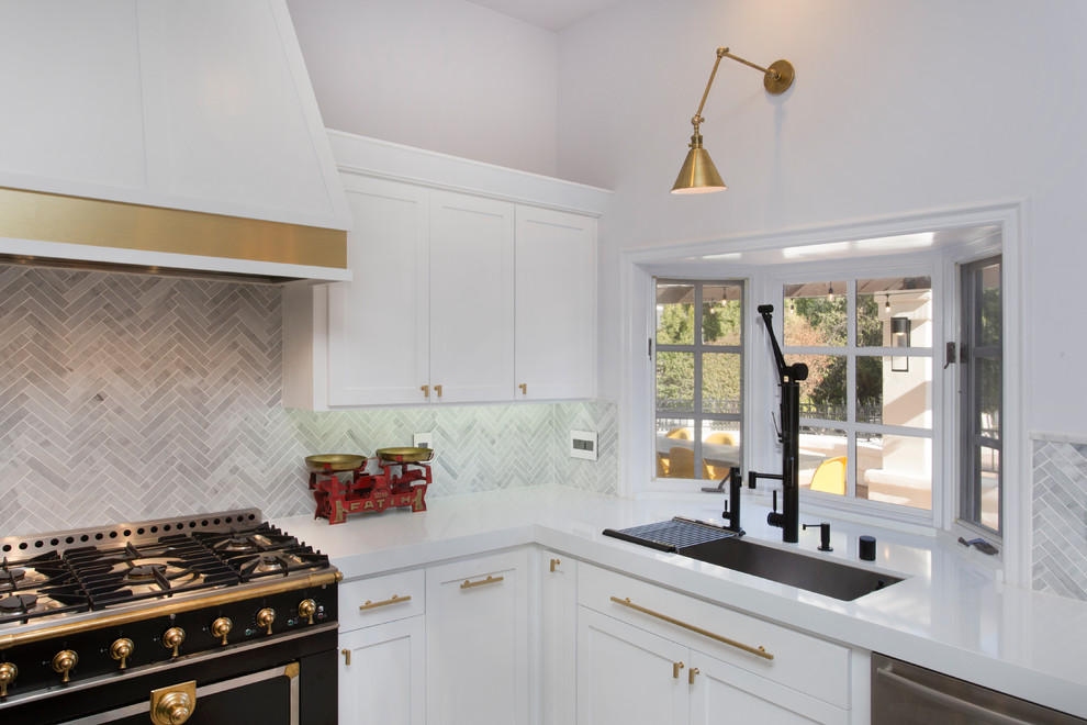 This is an example of a mid-sized eclectic u-shaped eat-in kitchen in Los Angeles with an undermount sink, shaker cabinets, white cabinets, quartz benchtops, grey splashback, matchstick tile splashback, black appliances, ceramic floors and with island.