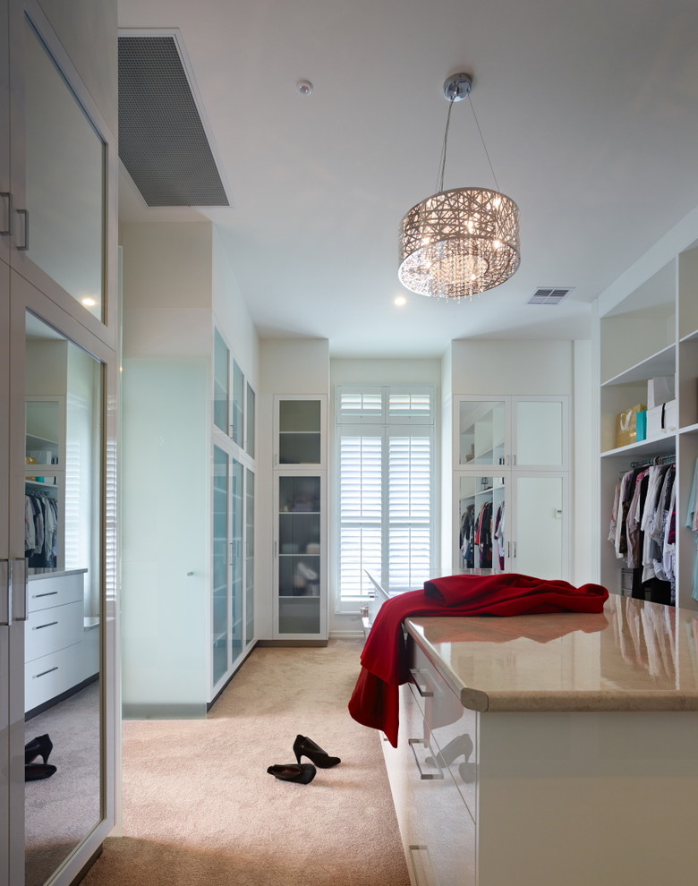 Design ideas for a large traditional gender-neutral walk-in wardrobe in Brisbane with glass-front cabinets, white cabinets and carpet.