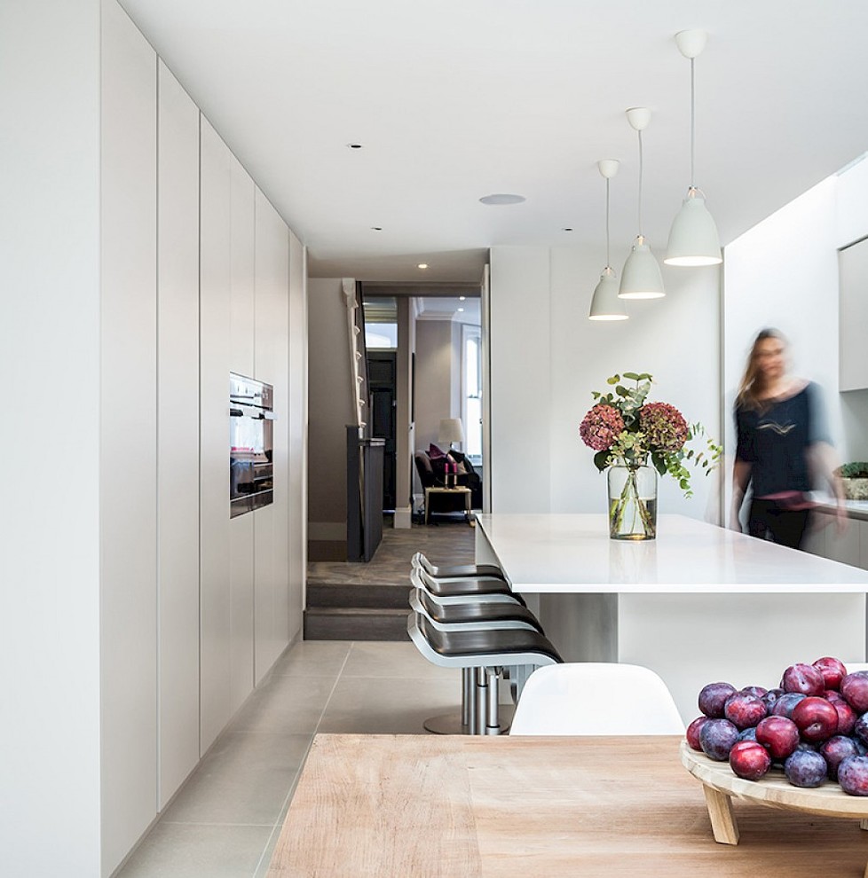 Design ideas for a contemporary galley eat-in kitchen in London with a peninsula and white benchtop.