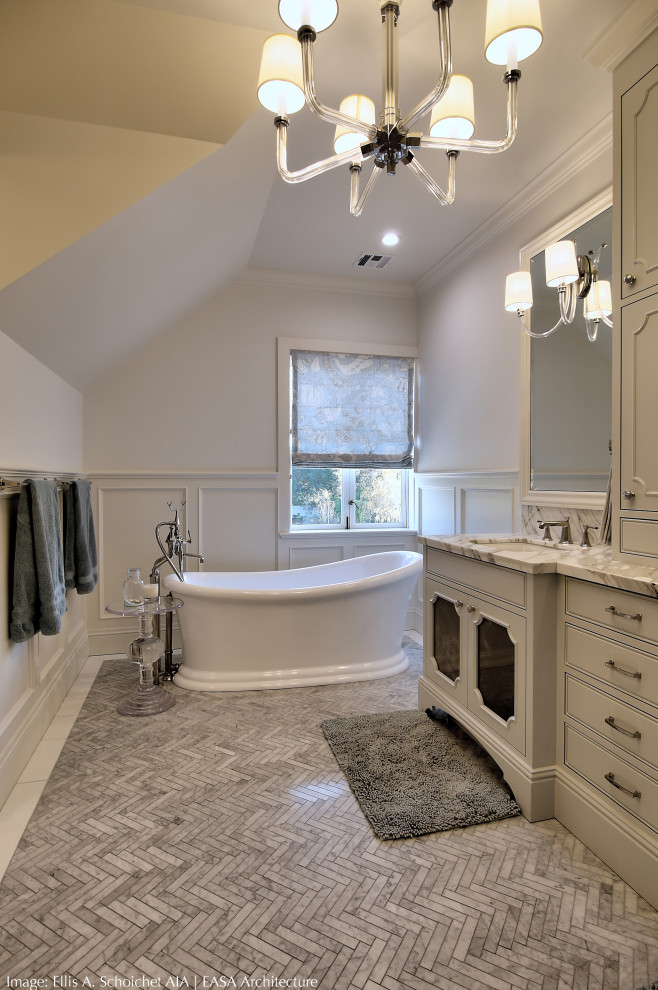 Example of a large classic master mosaic tile floor, gray floor, double-sink and wainscoting freestanding bathtub design in San Francisco with furniture-like cabinets, white cabinets, marble countertops, white countertops, white walls, an undermount sink and a built-in vanity