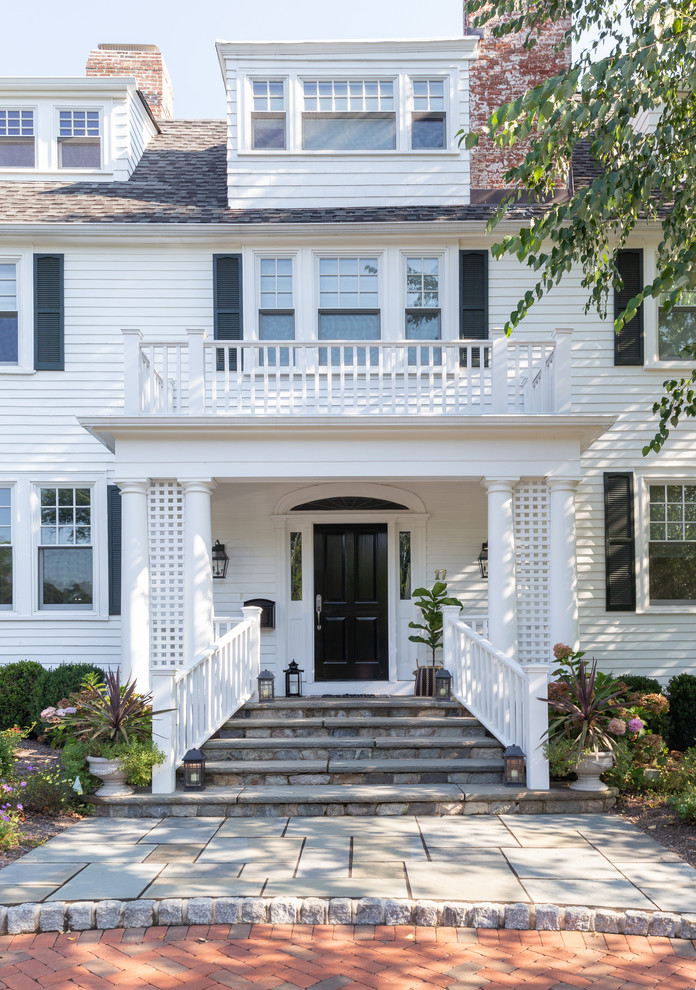Large beach style white three-story mixed siding house exterior photo in New York with a hip roof and a shingle roof