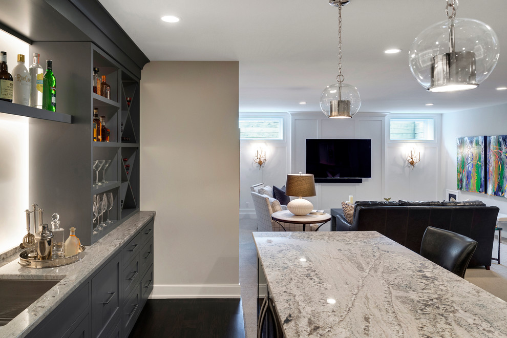 Large transitional single-wall wet bar in Minneapolis with an undermount sink, recessed-panel cabinets, grey cabinets, granite benchtops, white splashback and carpet.