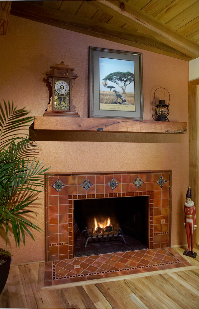 Living room in Phoenix with a standard fireplace and a tile fireplace surround.