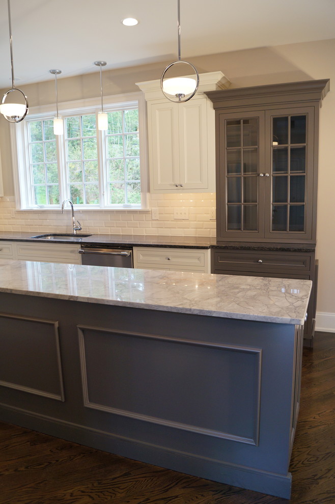 Mid-sized traditional u-shaped open plan kitchen in Philadelphia with an undermount sink, flat-panel cabinets, grey cabinets, granite benchtops, white splashback, subway tile splashback, stainless steel appliances, dark hardwood floors and with island.