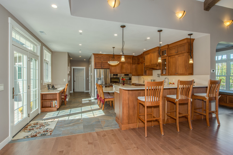 Open concept kitchen - huge transitional u-shaped open concept kitchen idea in Boston with an undermount sink, shaker cabinets, medium tone wood cabinets, quartz countertops, stone slab backsplash, stainless steel appliances and an island