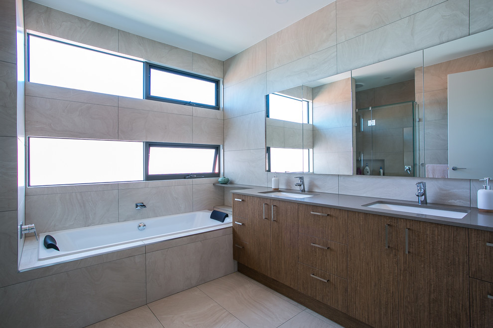 Photo of a mid-sized contemporary kids bathroom in Melbourne with medium wood cabinets and engineered quartz benchtops.