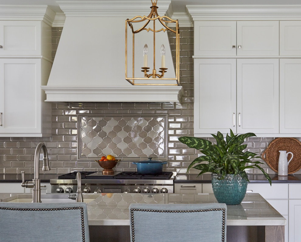 Kitchen - transitional kitchen idea in Chicago with shaker cabinets, white cabinets, quartz countertops, gray backsplash, ceramic backsplash and black countertops
