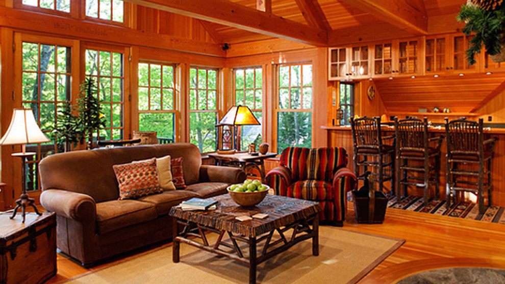 Photo of a large country sunroom in Denver with medium hardwood floors and a wood stove.