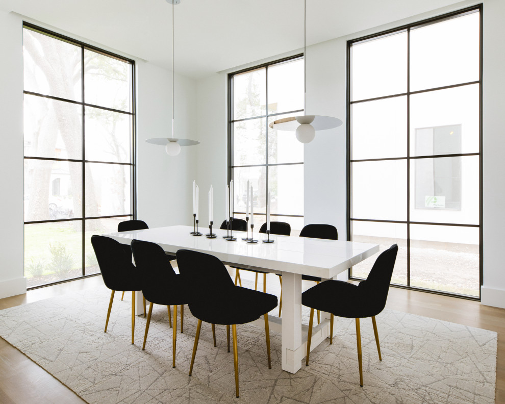 Inspiration for a contemporary medium tone wood floor and brown floor dining room remodel in Dallas with white walls