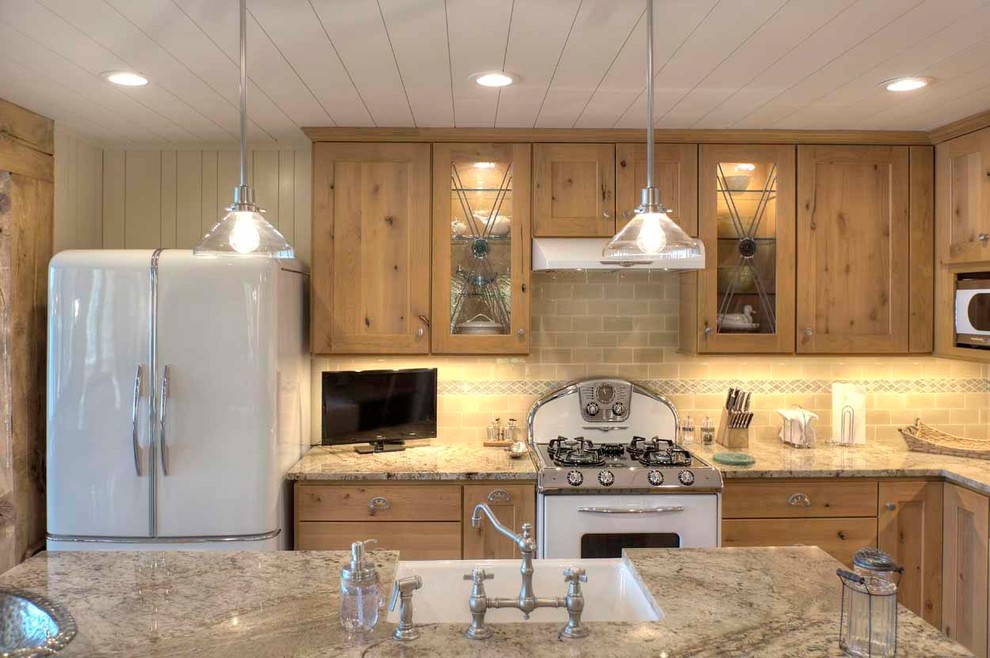 Inspiration for a transitional kitchen remodel with a farmhouse sink, granite countertops and white appliances
