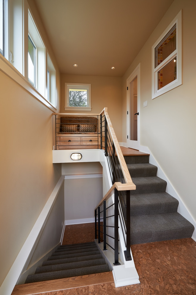 Design ideas for a mid-sized arts and crafts carpeted u-shaped staircase in Seattle with carpet risers and mixed railing.