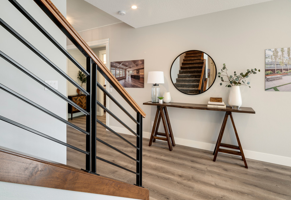 This is an example of a mid-sized contemporary carpeted straight staircase in Portland with carpet risers and metal railing.