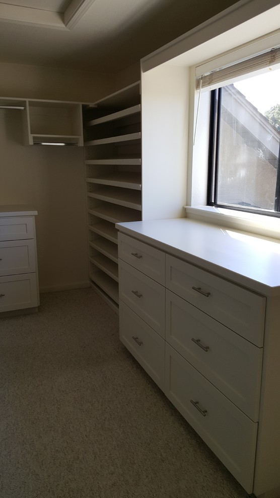 Expansive traditional gender-neutral walk-in wardrobe in Sacramento with shaker cabinets, white cabinets and carpet.