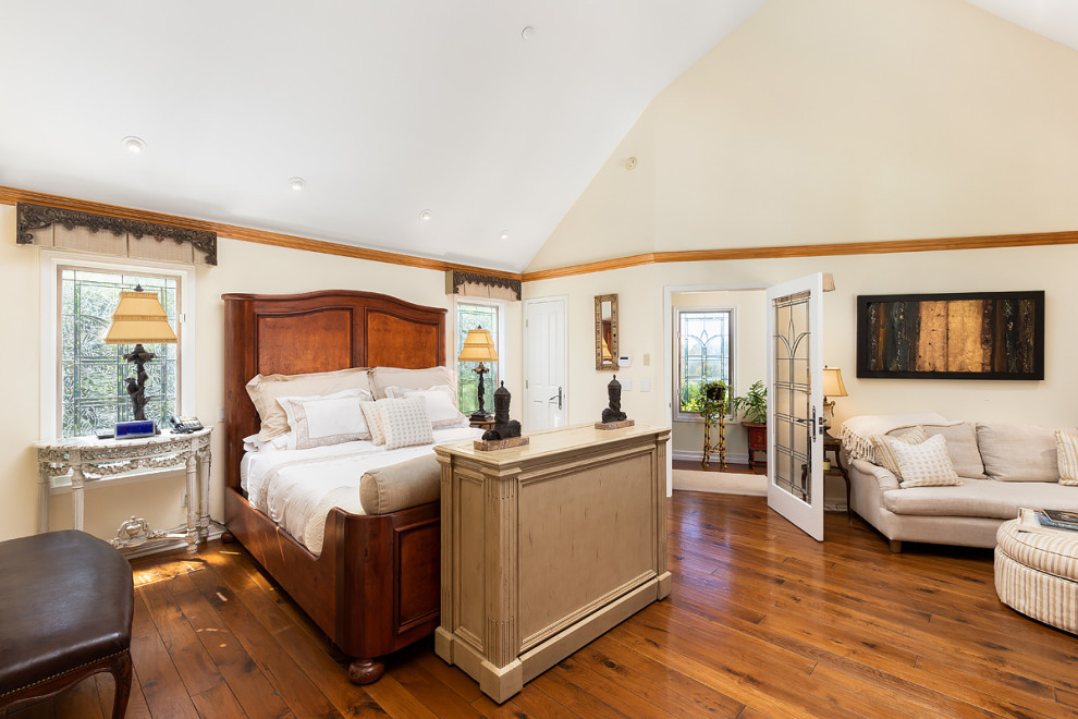 Photo of a large country master bedroom in Orange County.