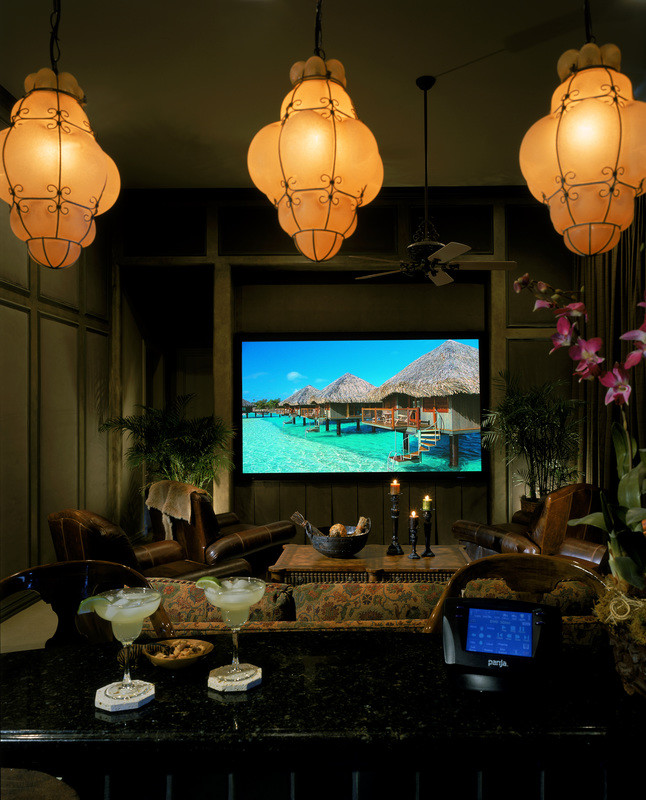Design ideas for a large tropical enclosed home theatre in San Diego with green walls, carpet and a built-in media wall.