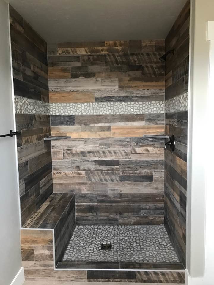 Doorless shower - rustic beige tile and ceramic tile pebble tile floor doorless shower idea with beige walls