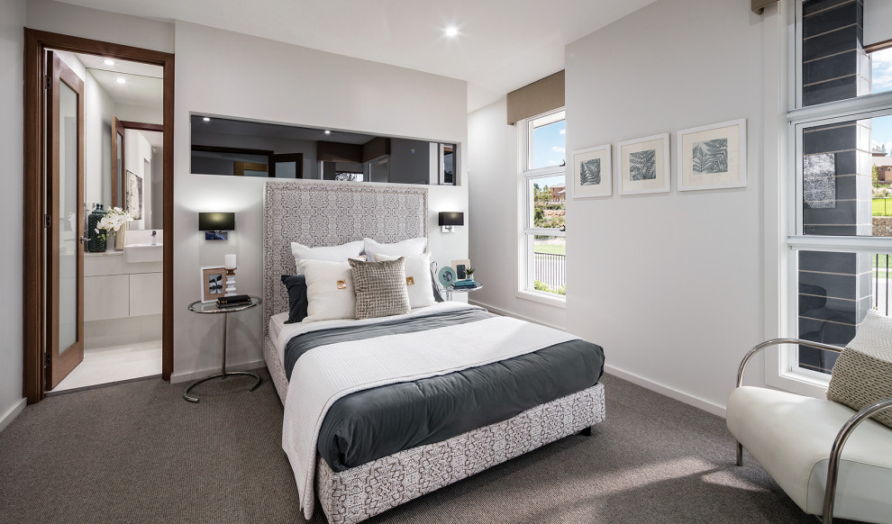 This is an example of a mid-sized contemporary master bedroom in Newcastle - Maitland with white walls, carpet and grey floor.