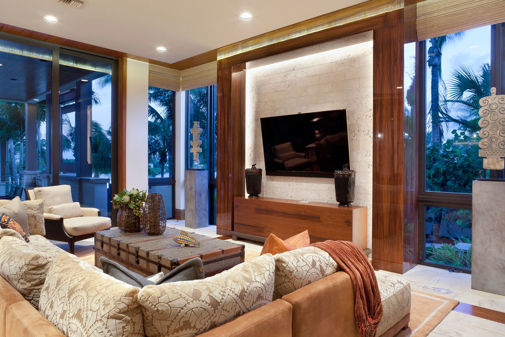 Tropical family room in Other with a wall-mounted tv.