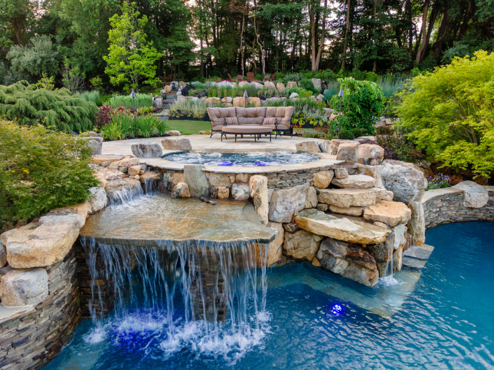 Inspiration for a country backyard custom-shaped natural pool in New York with with a pool and natural stone pavers.