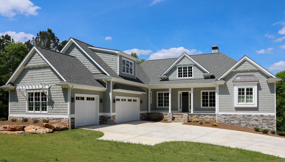 Photo of a large arts and crafts two-storey grey house exterior in Atlanta with concrete fiberboard siding, a gable roof, a shingle roof, a grey roof and shingle siding.