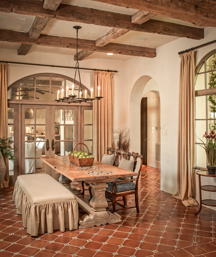 Photo of a mediterranean dining room in Houston with terra-cotta floors.