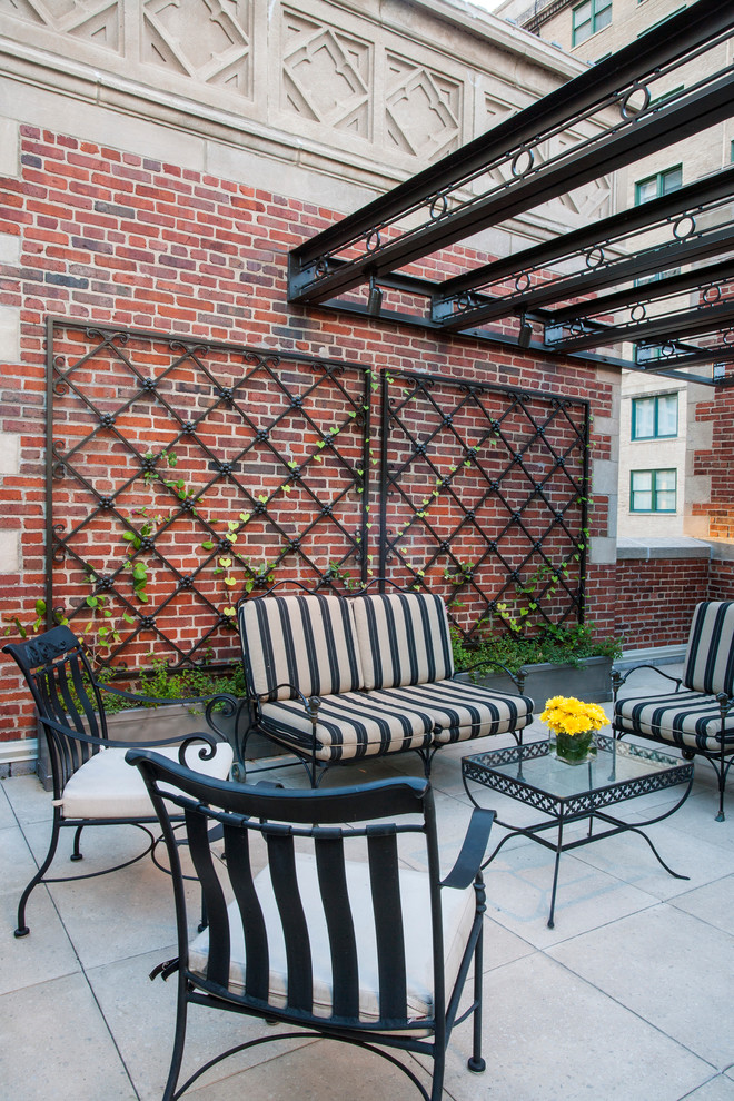 Traditional patio in Chicago with a vertical garden and a pergola.