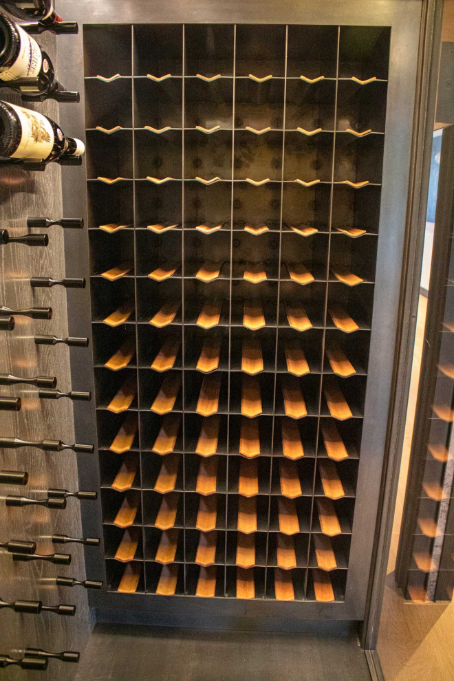 This is an example of a small traditional wine cellar in Other with painted wood flooring and storage racks.