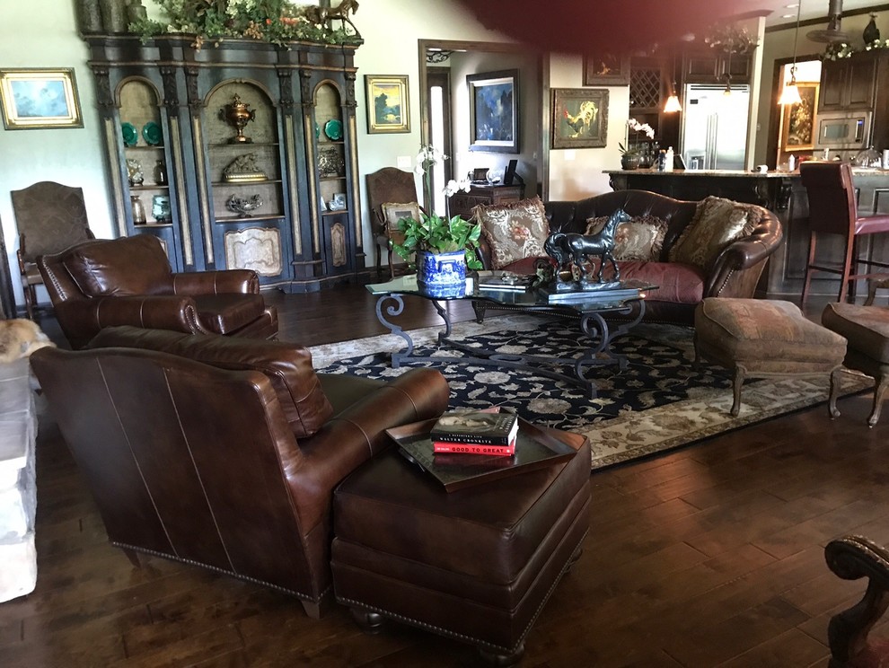 Inspiration for a traditional living room in Dallas with beige walls, dark hardwood floors, a standard fireplace, a stone fireplace surround, a wall-mounted tv and brown floor.