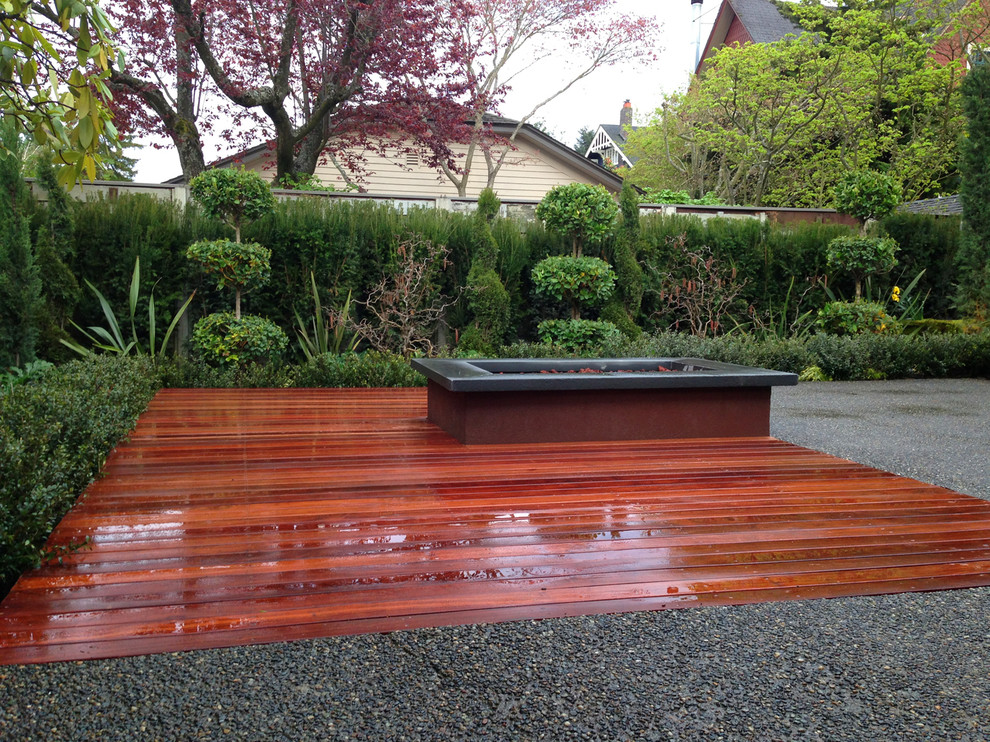 This is an example of a contemporary backyard deck in Seattle with a fire feature.