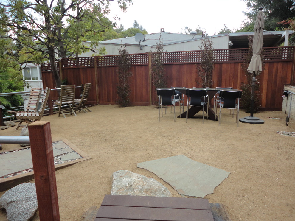 Inspiration for a mid-sized country backyard full sun xeriscape in Los Angeles with concrete pavers.