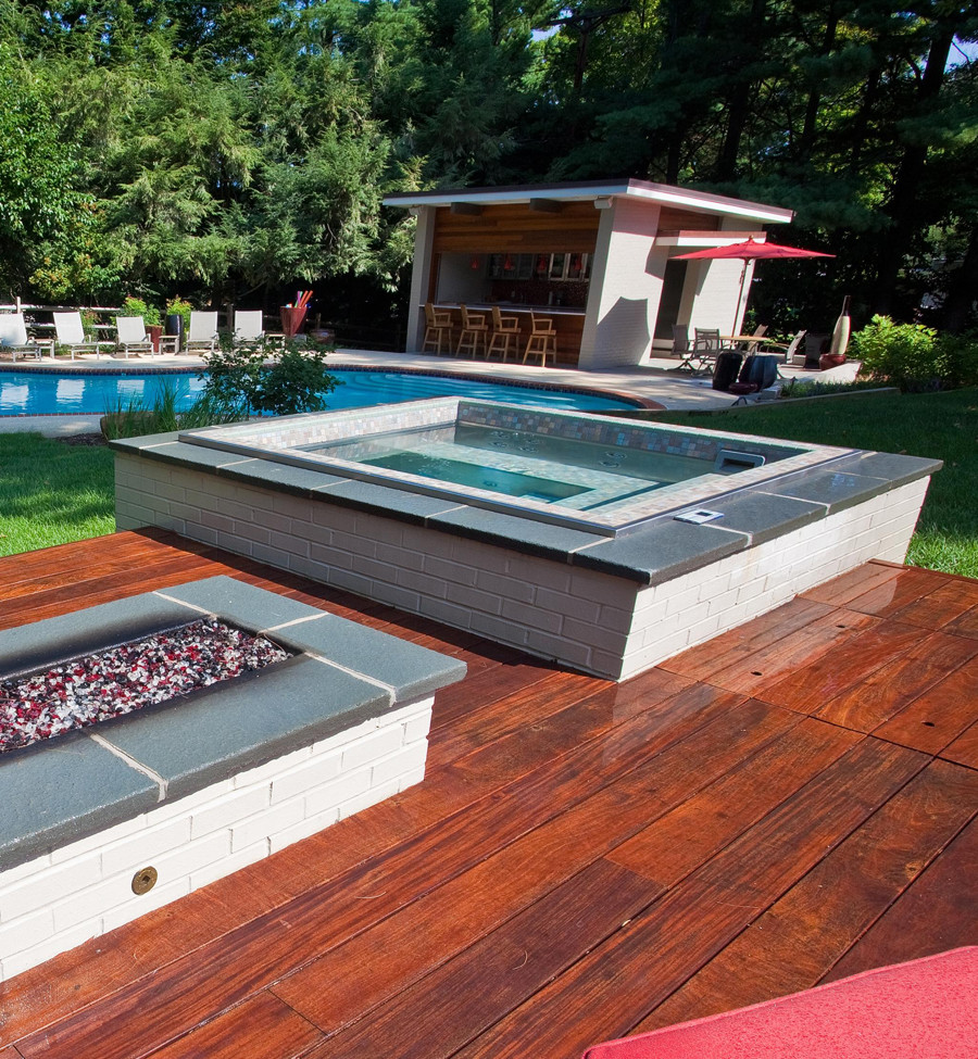 Design ideas for a contemporary backyard rectangular aboveground pool in Other with a hot tub and decking.
