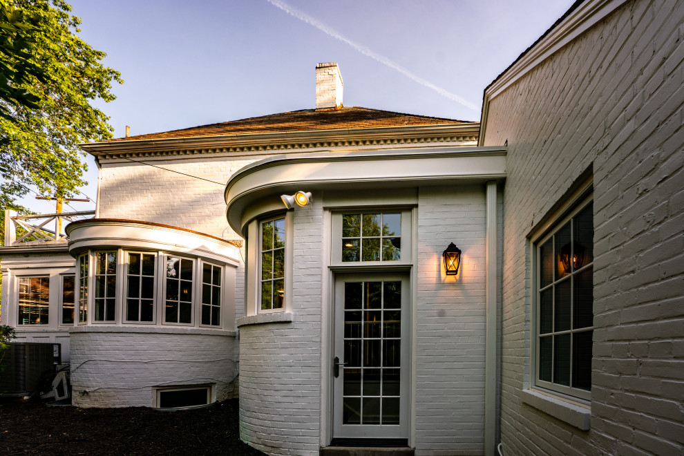 Photo of a mid-sized arts and crafts split-level white exterior in DC Metro with painted brick siding.