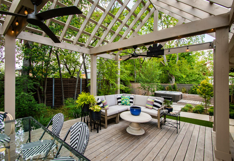 Transitional deck in Dallas with a pergola.