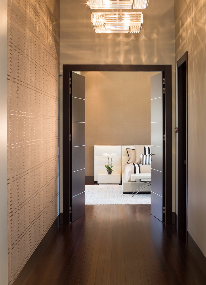 This is an example of an expansive contemporary master bedroom in San Francisco with beige walls and bamboo floors.