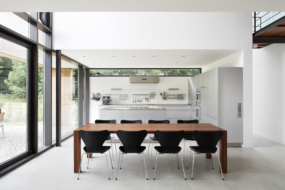 This is an example of a modern open plan dining in Dortmund with white walls.