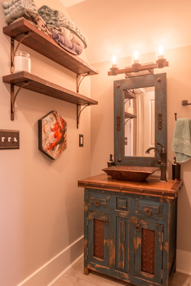 This is an example of an arts and crafts 3/4 bathroom in Other with recessed-panel cabinets, dark wood cabinets, an alcove shower, multi-coloured tile, ceramic tile, ceramic floors, a vessel sink and wood benchtops.