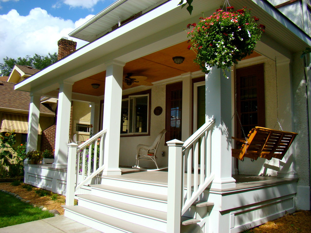 Inspiration for a mid-sized traditional front yard verandah in Minneapolis with decking and a roof extension.