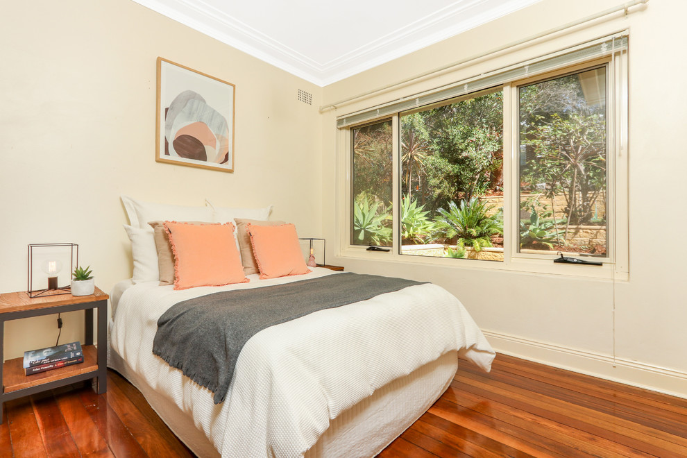 Inspiration for a transitional bedroom in Sydney with beige walls, medium hardwood floors and brown floor.