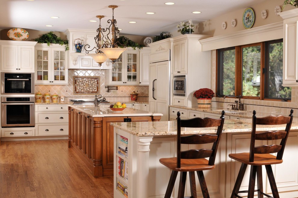 Large transitional u-shaped medium tone wood floor and brown floor eat-in kitchen photo in Denver with raised-panel cabinets, white cabinets, stainless steel appliances, an undermount sink, granite countertops, beige backsplash and ceramic backsplash