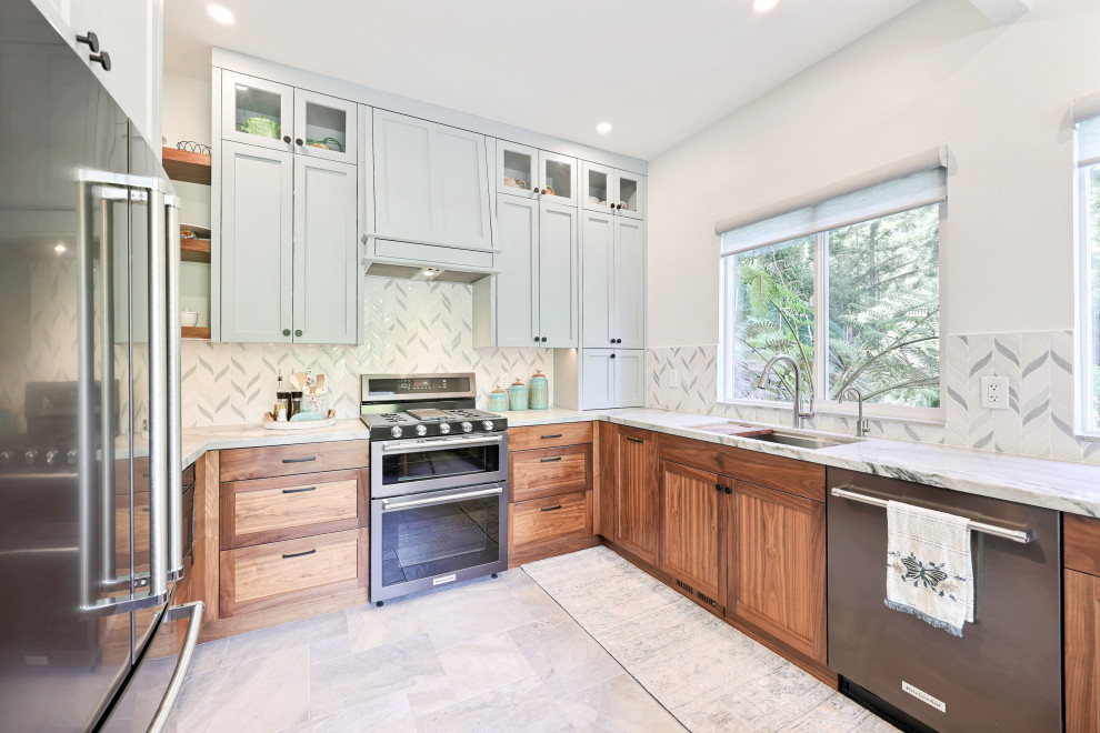 Example of a mid-sized beach style slate floor eat-in kitchen design in San Francisco with a single-bowl sink, shaker cabinets, medium tone wood cabinets, quartzite countertops, blue backsplash, mosaic tile backsplash and black appliances