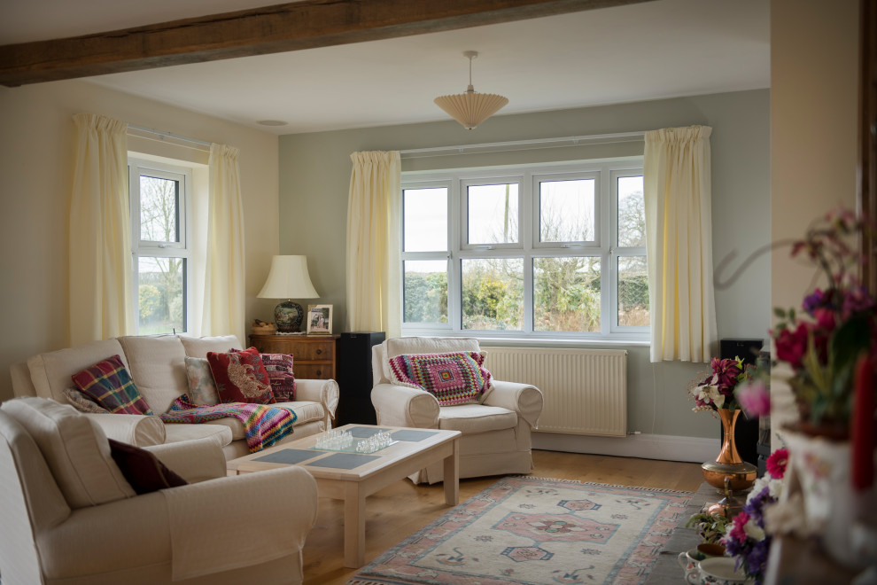 This is an example of a medium sized traditional grey and cream open plan living room curtain with a music area, beige walls, terracotta flooring, no fireplace, a brick fireplace surround, no tv, grey floors, exposed beams, brick walls and curtains.