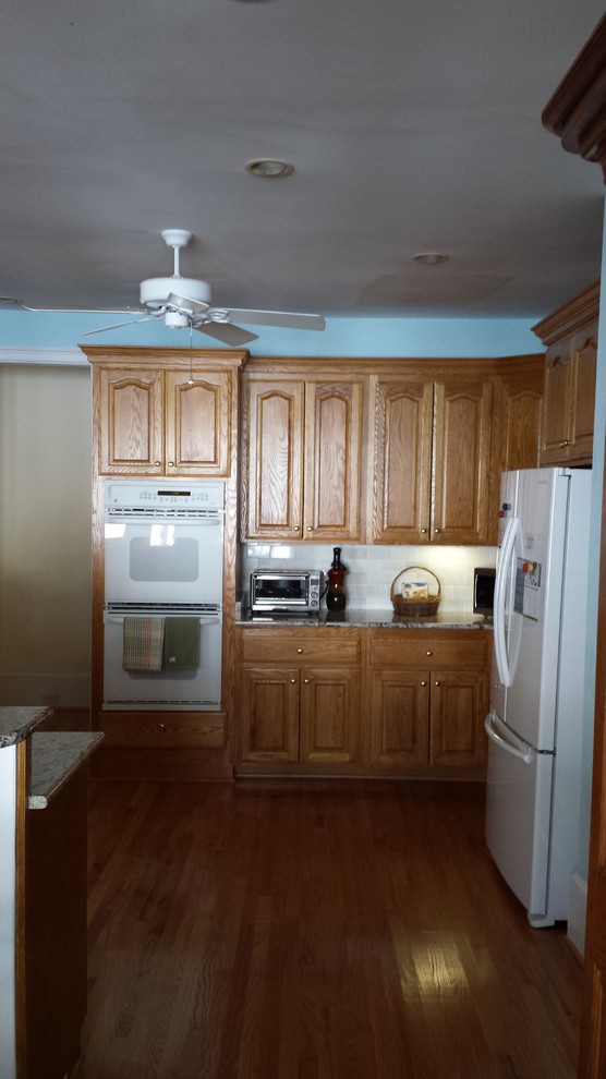 Inspiration for a transitional kitchen remodel with shaker cabinets, white cabinets and an island