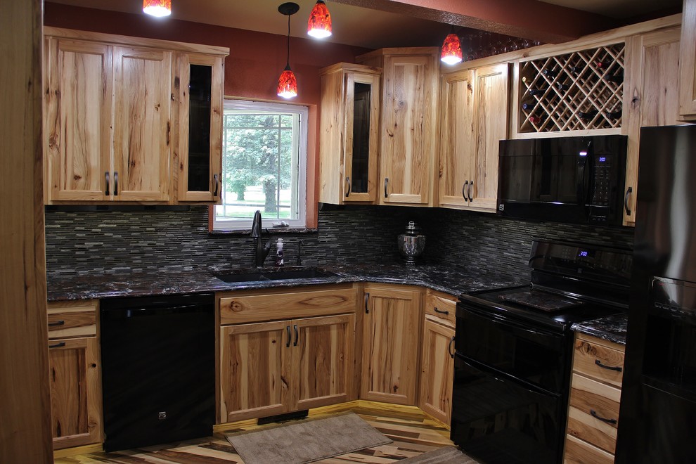 Eat-in kitchen - large rustic l-shaped medium tone wood floor eat-in kitchen idea in Minneapolis with an undermount sink, flat-panel cabinets, light wood cabinets, quartz countertops, black backsplash, glass tile backsplash, black appliances, red walls and no island