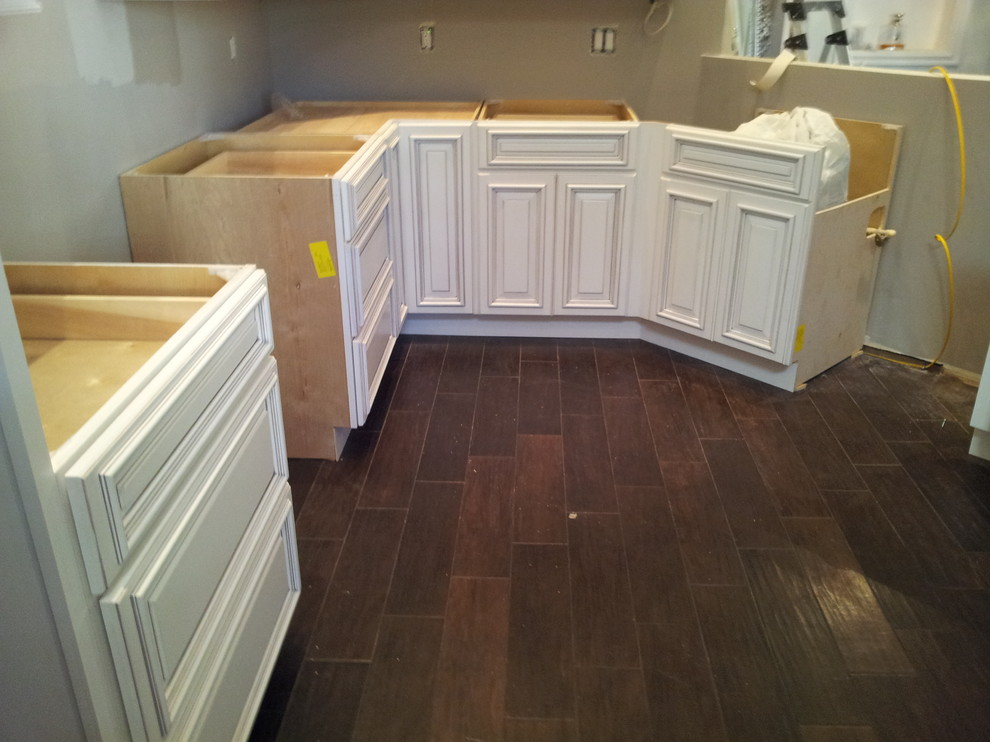 Traditional eat-in kitchen in Orlando with raised-panel cabinets.